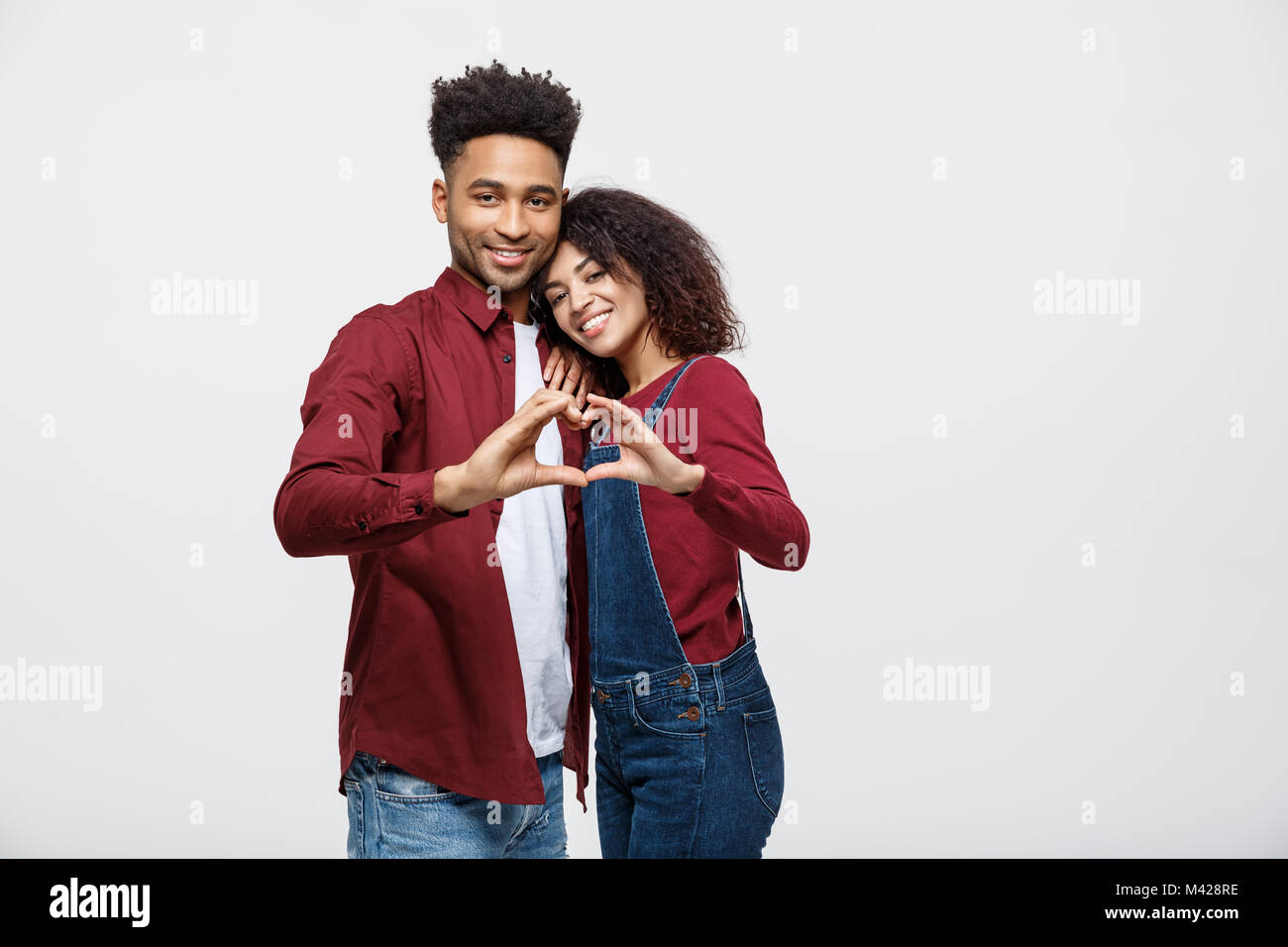 Portrait of a smiling young african couple dressed in casual clothes ...