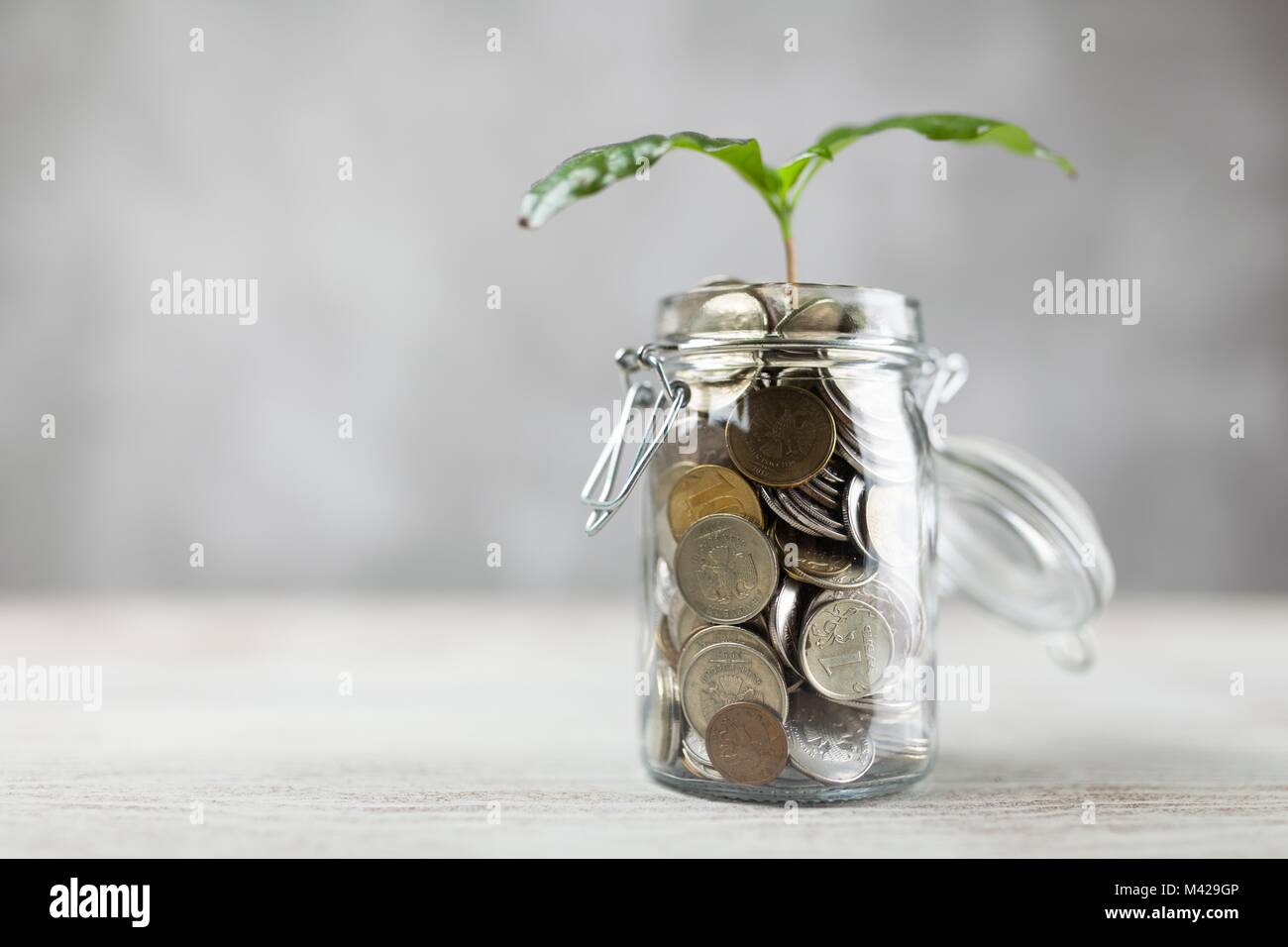 Coins in a glass jar Stock Photo