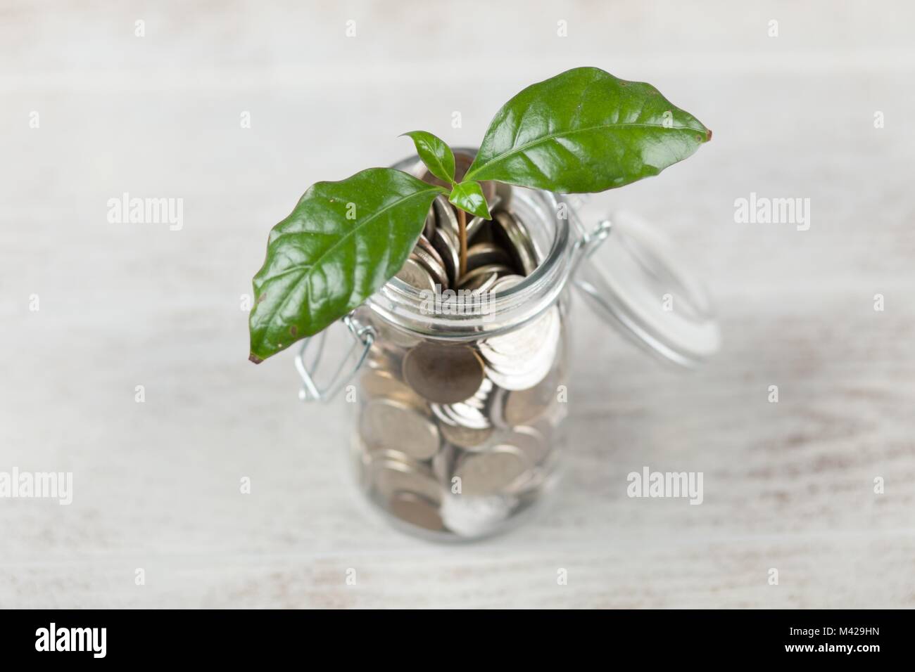 Coins in a glass jar Stock Photo