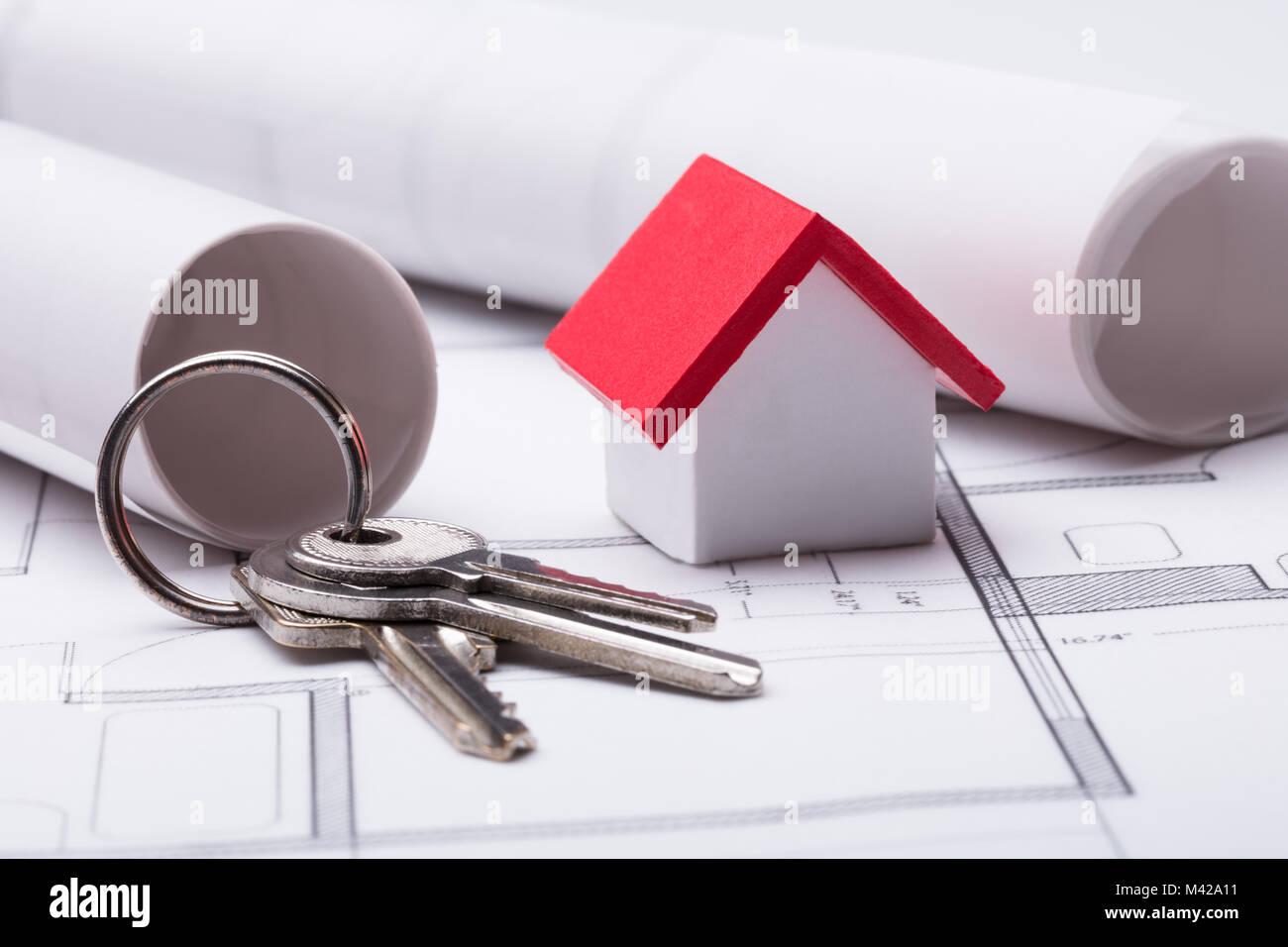 Close-up Of House Model And Keys On Blueprint Stock Photo