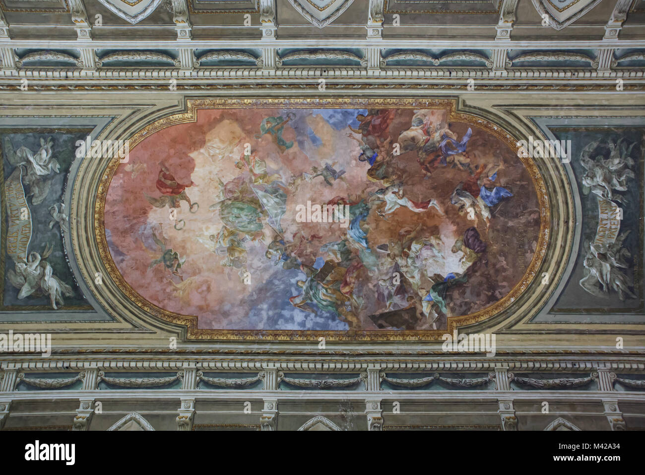Ceiling painting by Italian Rococo painter Pietro Bardellino in the Salone della Meridiana in the Palazzo deli Studi, now served as the National Archaeological Museum in Naples, Campania, Italy. The large scale ceiling fresco glorifying King Ferdinand IV of Naples and his spouse Maria Carolina of Austria was created in 1781 to decorate the hall designed by Italian architect Giovanni Antonio Medrano. Stock Photo