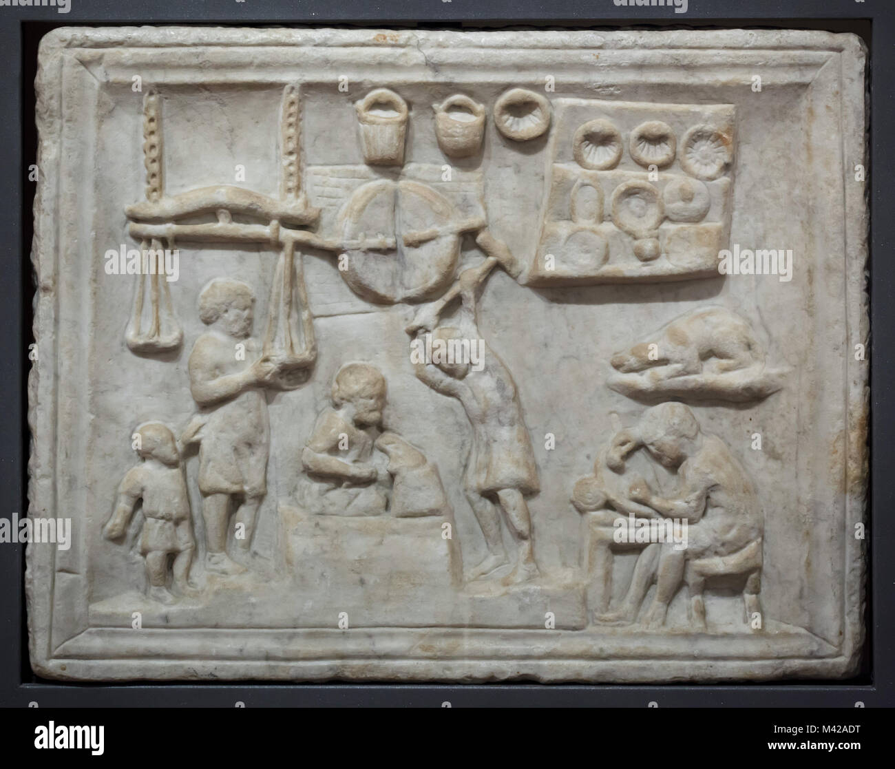 Blacksmith workshop depicted in the Roman marble relief from the 1st century AD from Pompeii from the Borgia Collection on display in the National Archaeological Museum in Naples, Campania, Italy. Stock Photo