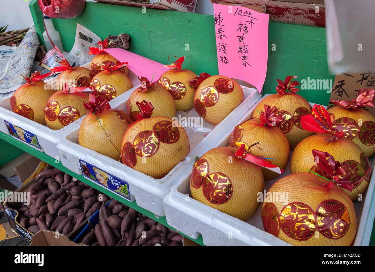 Pomelos stick with good luck stickers in San Francisco Chinatown market
