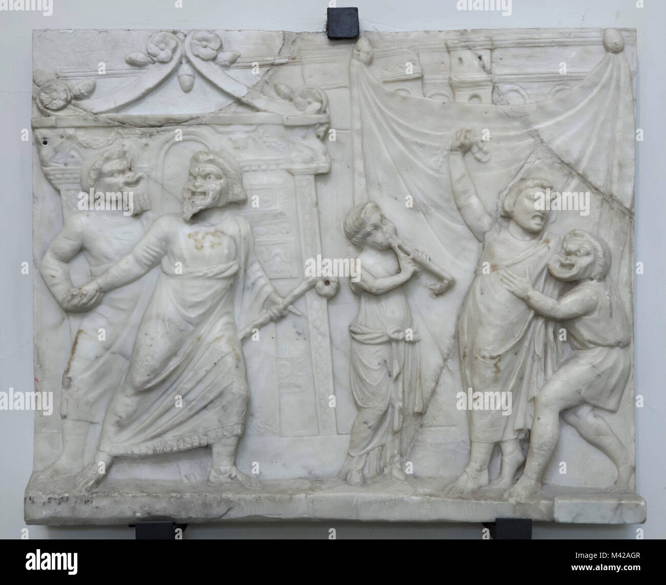 Theatrical scene depicted in the Roman marble relief from the 1st century AD from the Farnese Collection on display in the National Archaeological Museum in Naples, Campania, Italy. Stock Photo