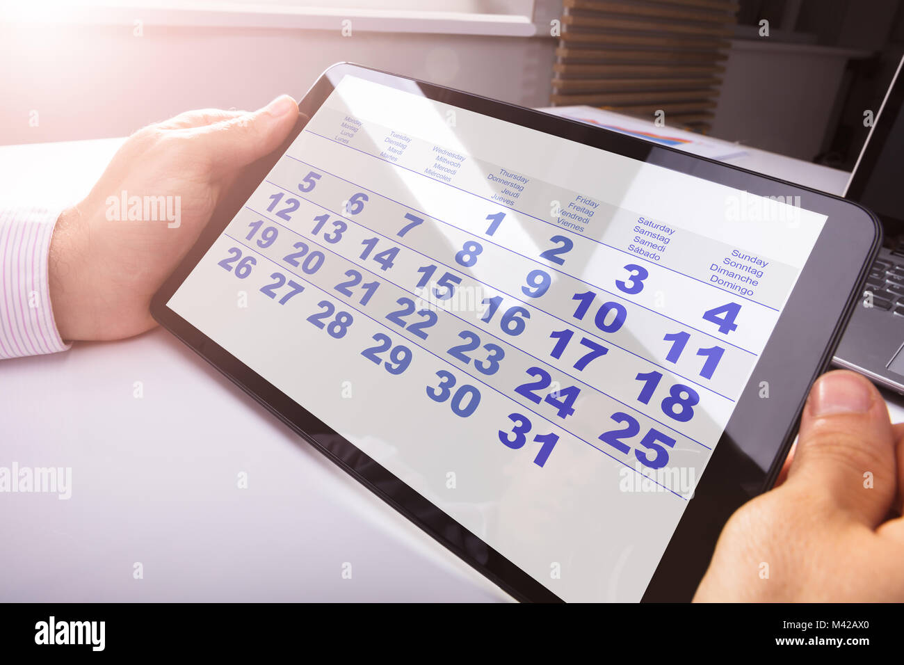Closeup Of A Man Looking At Calendar On Digital Tablet Stock Photo Alamy