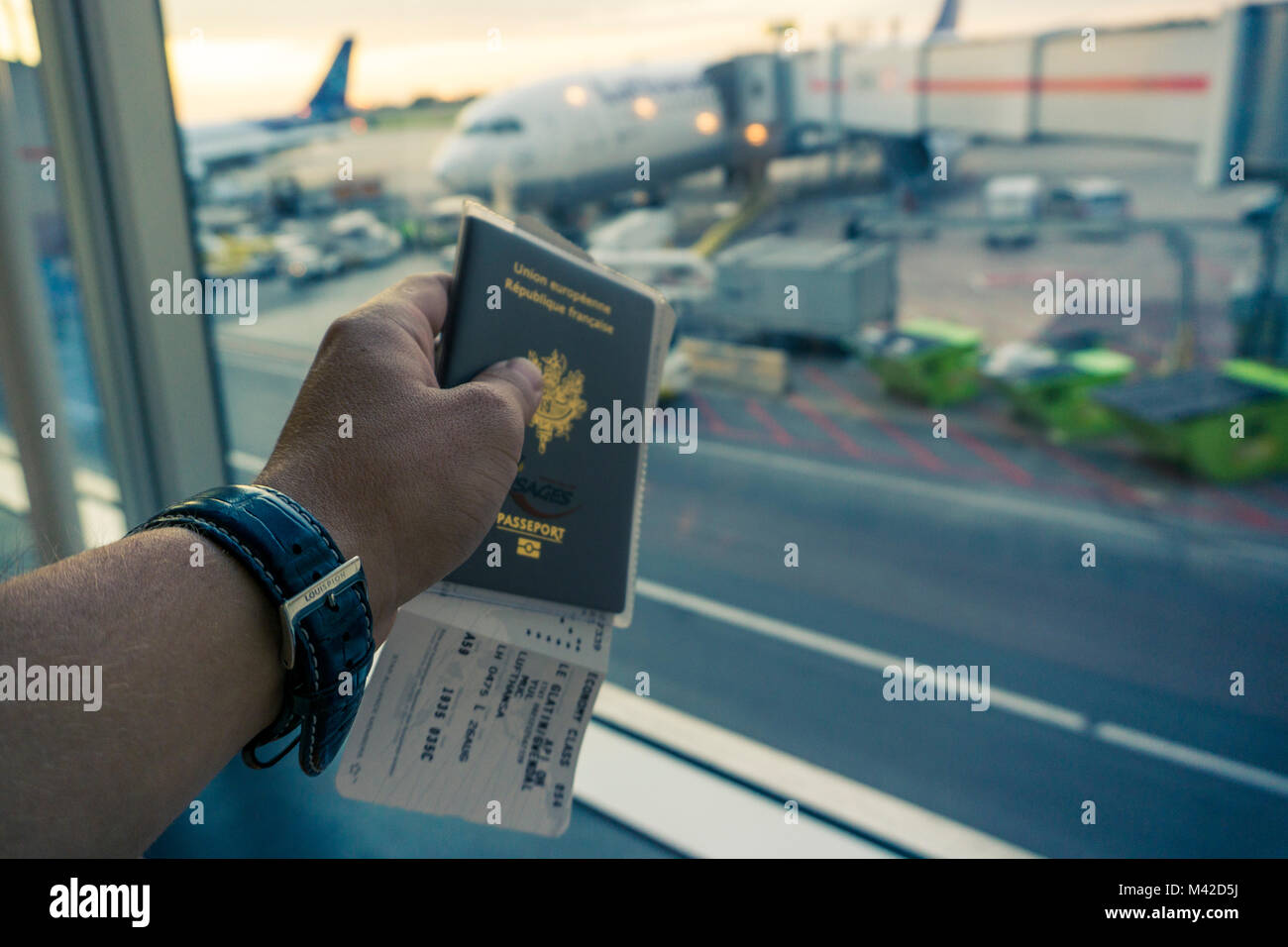hand, watch and passport at YYZ Toronto airport at sunset Stock Photo