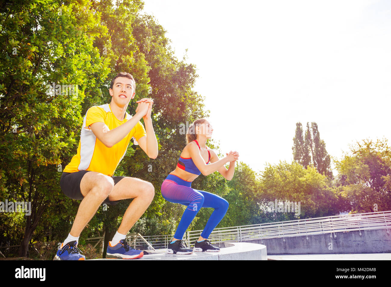 Sporty couple doing jump exercise during crossfit workout at outdoor