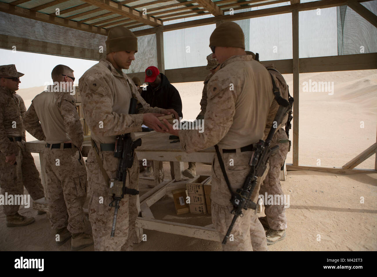 U.S. Marines with Headquarters and Service Company, Ground Combat Element, Special Purpose Marine Air-Ground Task Force – Crisis Response – Central Command, prepare the necessary ammunition to conduct a combat marksmanship program live-fire range, Jan. 23, 2018. The purpose of the training was to increase lethality, solidify warrior ethos, and shoot in a variety of conditions. Stock Photo