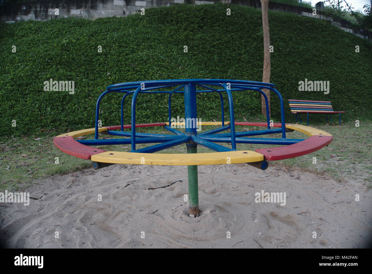 An empty colorful roundabout at a playground. Stock Photo