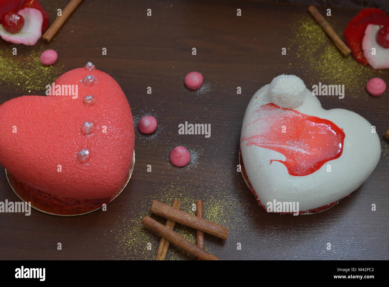 Two Valentine Cakes On A Wooden Table Cupcakes With Decorations