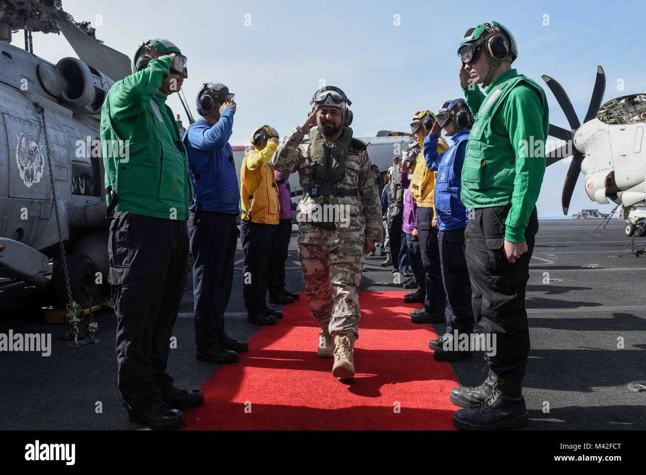 ARABIAN GULF (Feb. 6, 2018) Sideboys render honors to Qatar Emiri Naval Forces Maj. Gen. Abdullah Hassan Al-Sulaiti on the flight deck of the aircraft carrier USS Theodore Roosevelt (CVN 71). Theodore Roosevelt and its carrier strike group are deployed to the U.S. 5th Fleet area of operations in support of maritime security operations to reassure allies and partners and preserve the freedom of navigation and the free flow of commerce in the region. (U.S. Navy Stock Photo