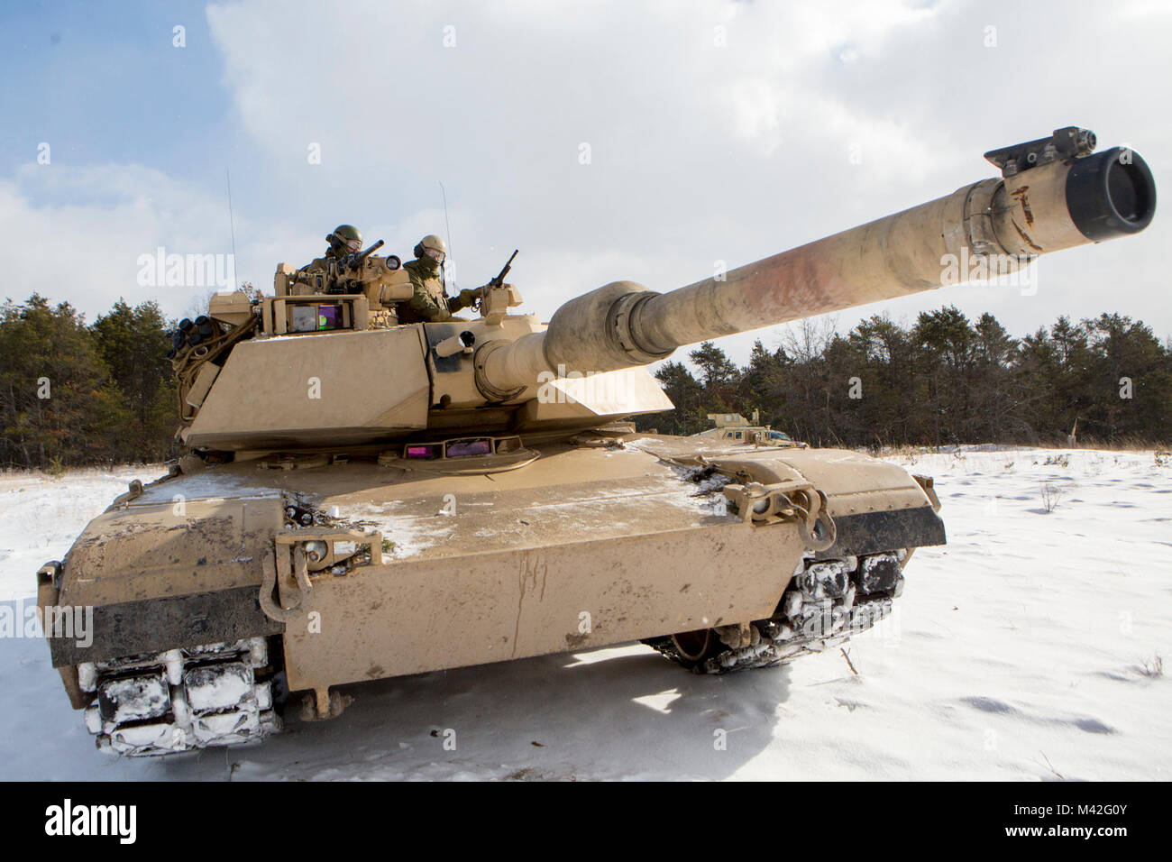 Marines with Company F, 4th Tank Battalion, 4th Marine Division, pause to check the scheme of maneuver before a platoon formation rehearsal during exercise Winter Break 2018 near Camp Grayling, Michigan, Feb. 8, 2018. Winter Break 18 challenges Marines of Fox Co., 4th Tank Bn. to contend with employment problems caused by extreme cold weather and snow and adapt to the operational challenges of a severe climate. Stock Photo