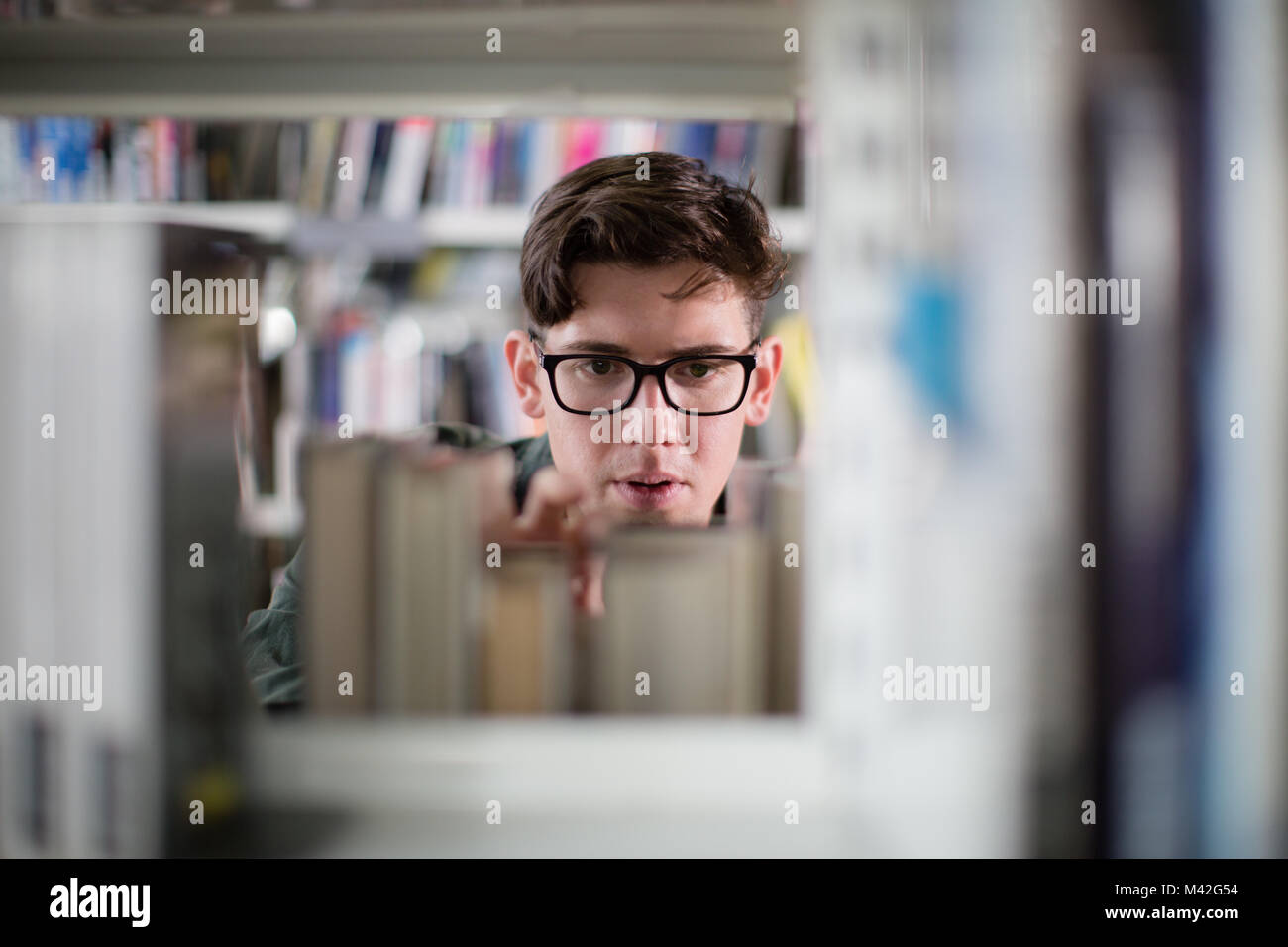 Student looking for a book in library Stock Photo