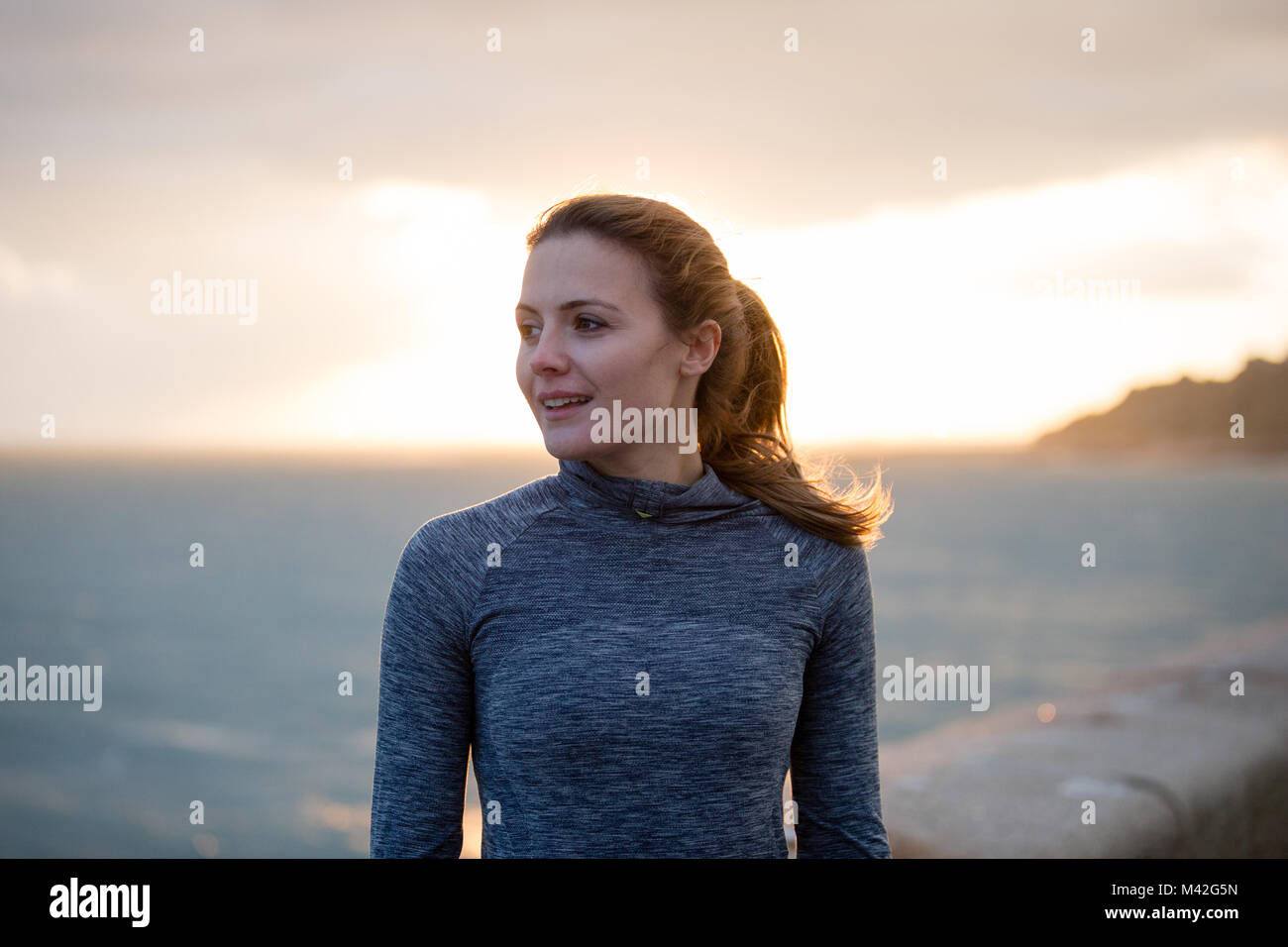 Young adult female exercising outdoors Stock Photo