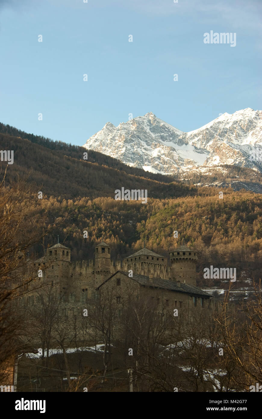 The Castle of Sarriot de la Tour with its towers and the Alpes of Aosta Valley in background. Saint-Pierre, Italy Stock Photo