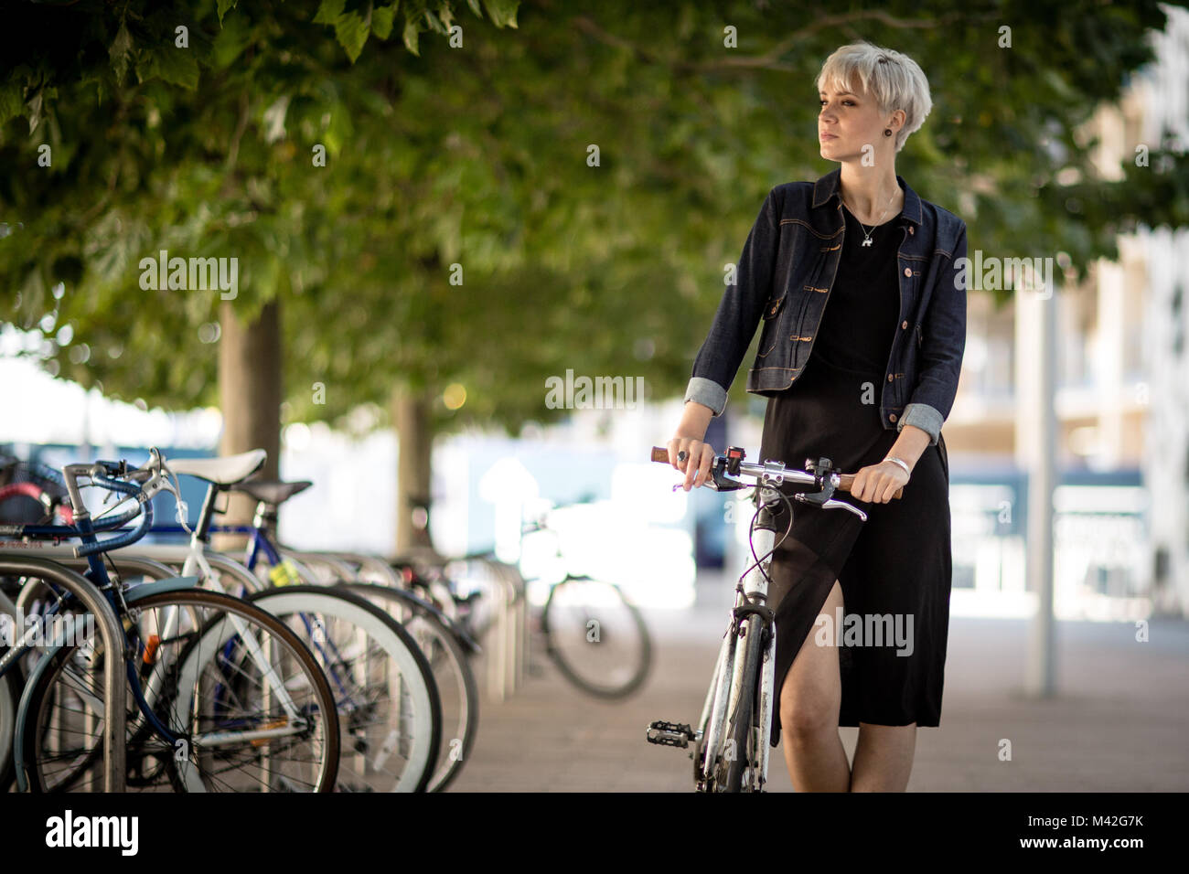 Young adult commuting on bike Stock Photo