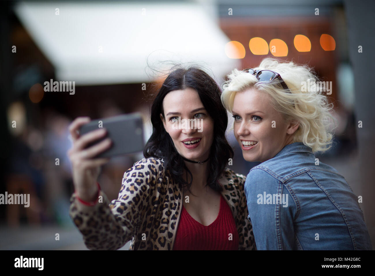 Female friends taking a selfie on a night out Stock Photo