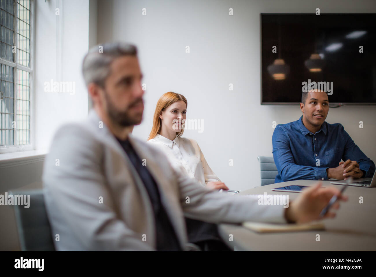 Colleagues listening in a business meeting Stock Photo