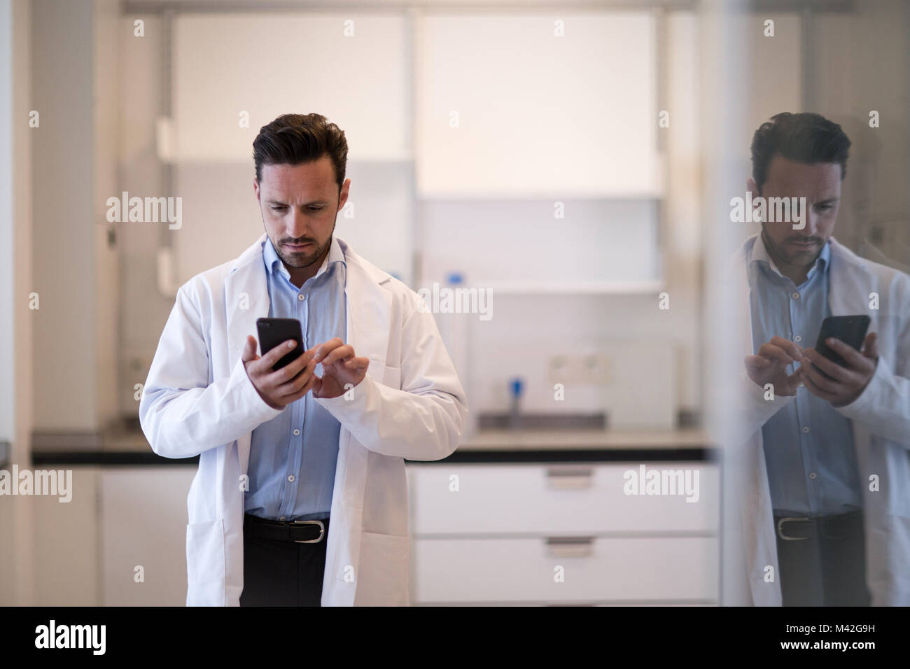 Male scientist using smartphone in laboratory Stock Photo