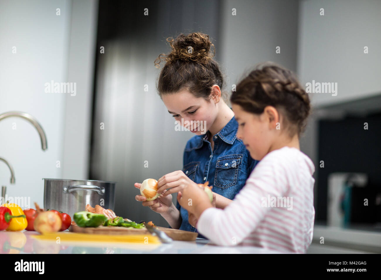 Sisters cooking a meal together Stock Photo