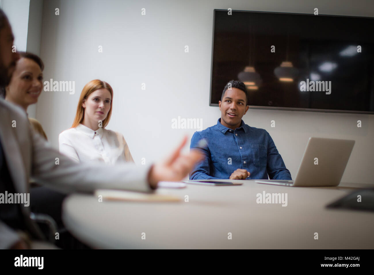 Colleagues having a discussion in a business meeting Stock Photo
