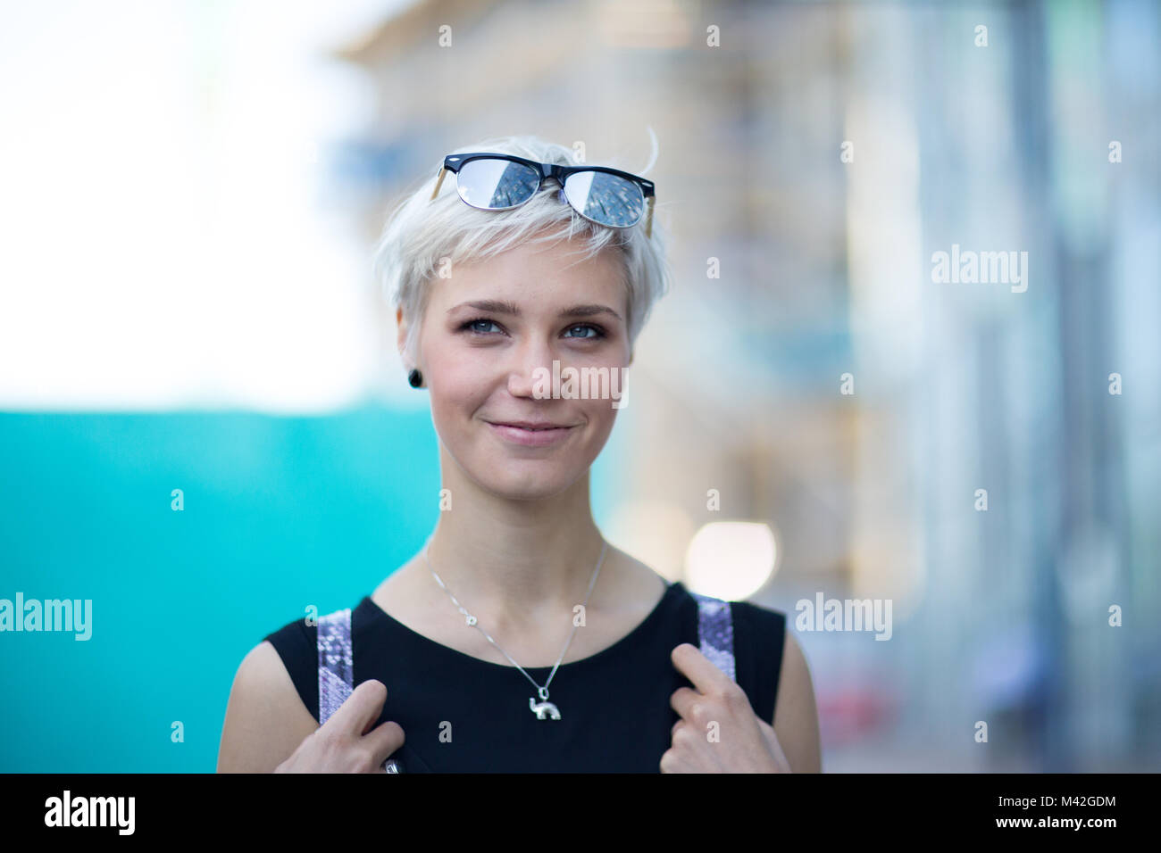 Young adult walking down street in a city Stock Photo