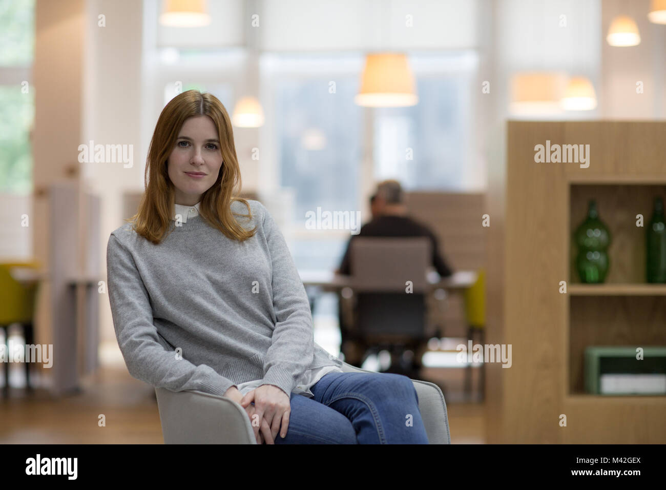 Portrait of female entrepreneur in a modern shared workplace Stock Photo