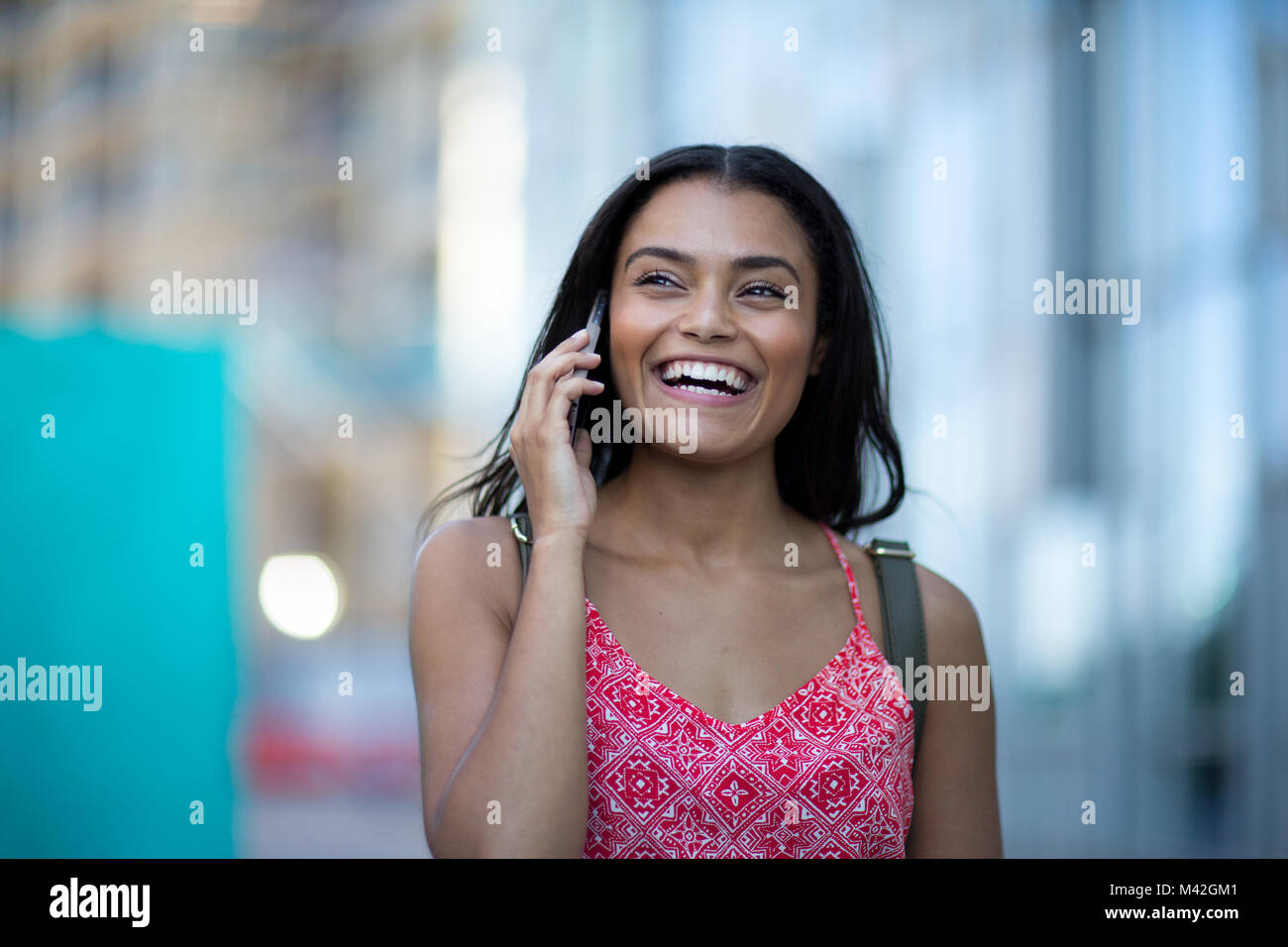 Young adult commuting and using smartphone Stock Photo