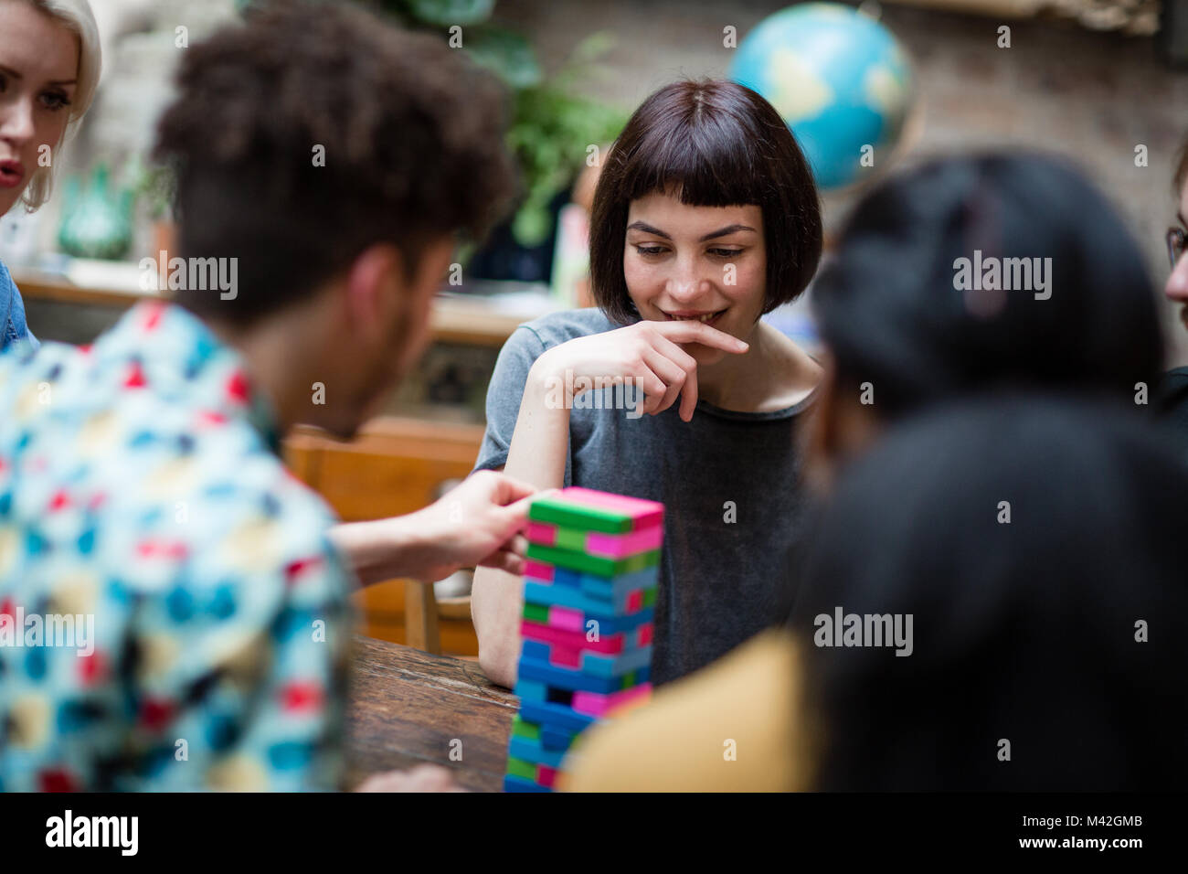 Group of friends playing retro game in pub Stock Photo