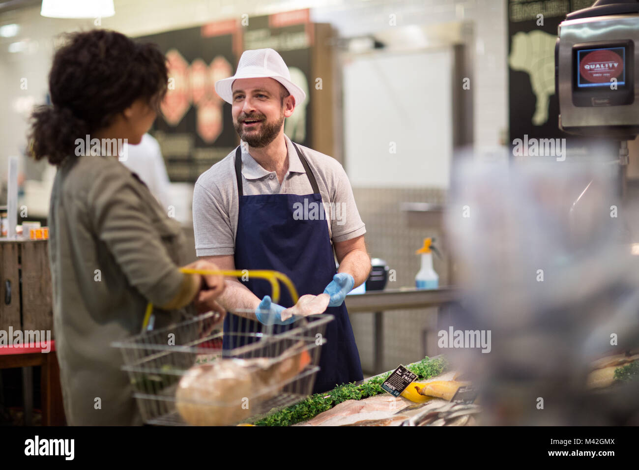 Customer asking fishmonger for advice Stock Photo