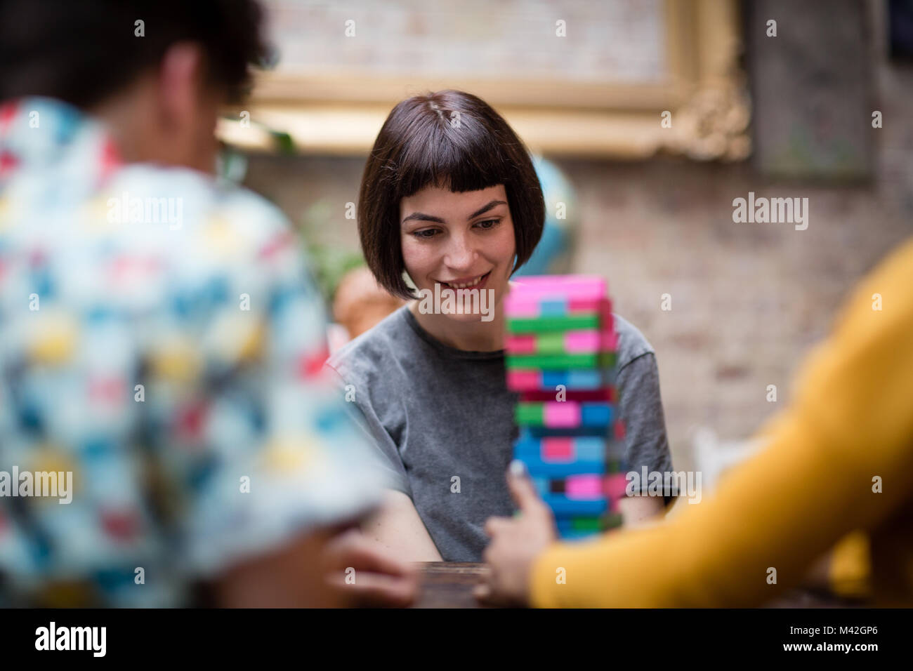 Group of friends playing retro game in pub Stock Photo