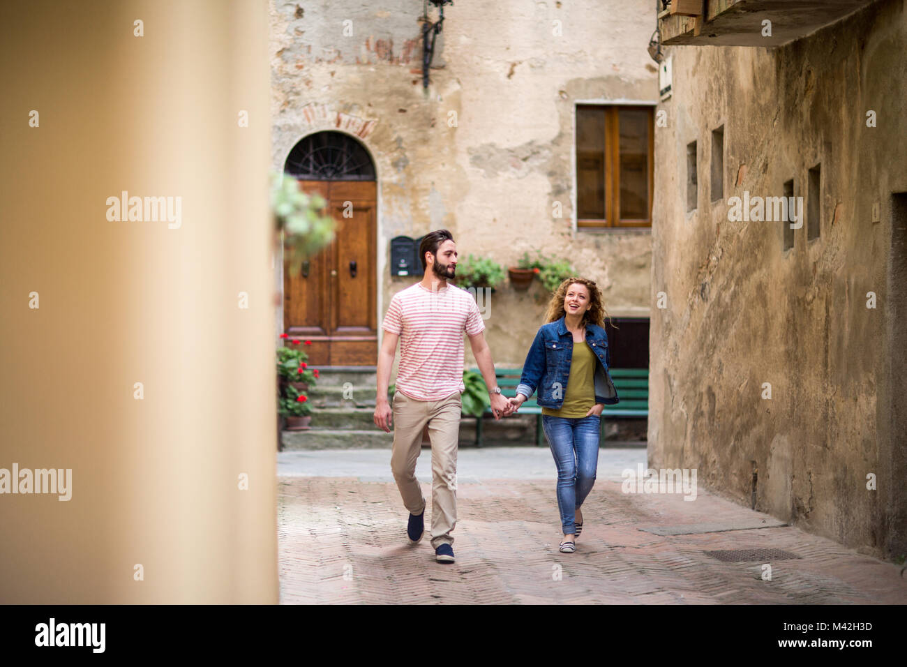 Young couple walking down street on vacation Stock Photo