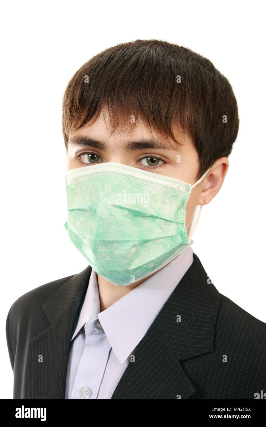 A teenager in a jacket with a protective medical mask on his face. Protection against viral infections Stock Photo