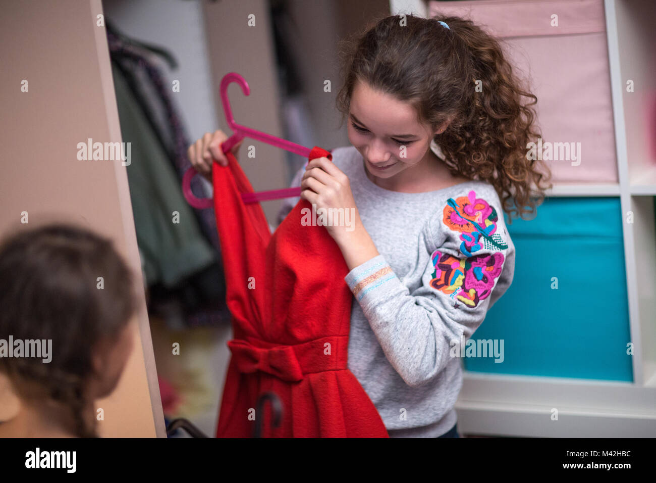 Sisters picking a dress to wear Stock Photo