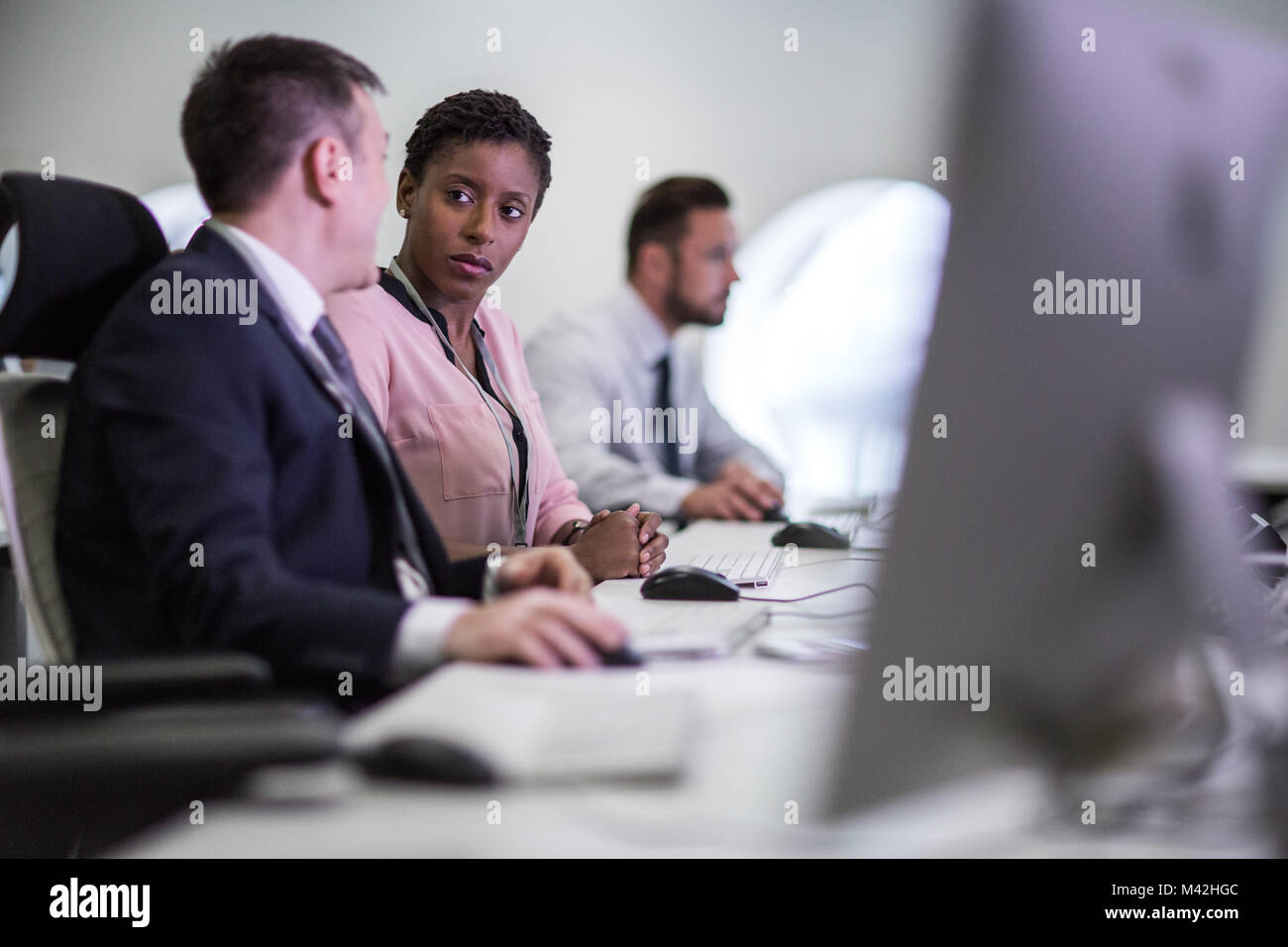 Colleagues in an office talking together Stock Photo