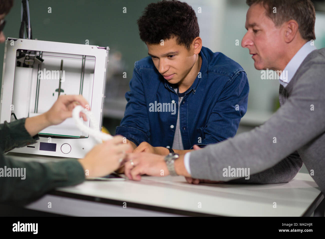 Students looking at a design for 3D model Stock Photo