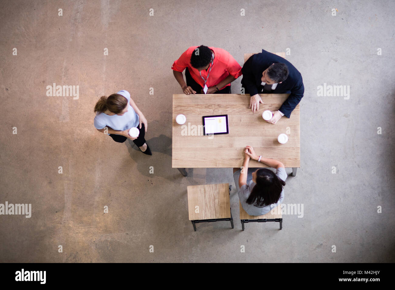 Overhead shot of woman arriving to a business meeting Stock Photo