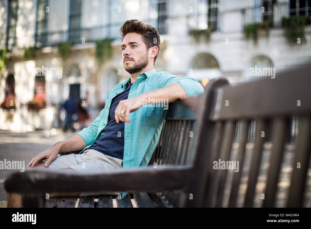 Tourist sitting on bench in London Stock Photo