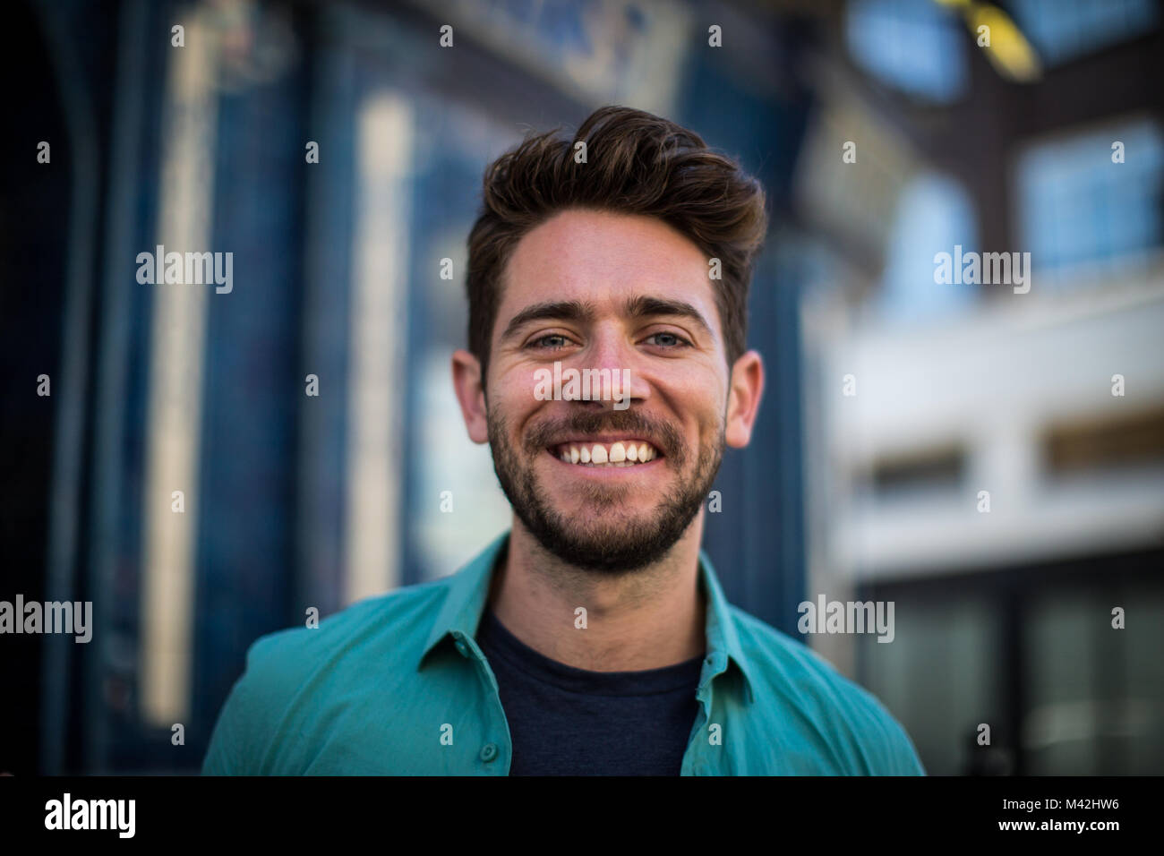 Young adult standing outside London pub Stock Photo