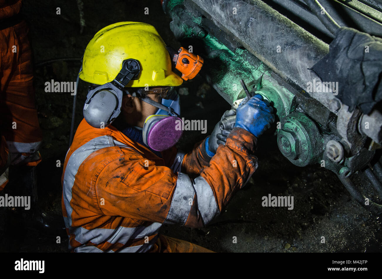 Miner fixing mineral extraction machine Stock Photo