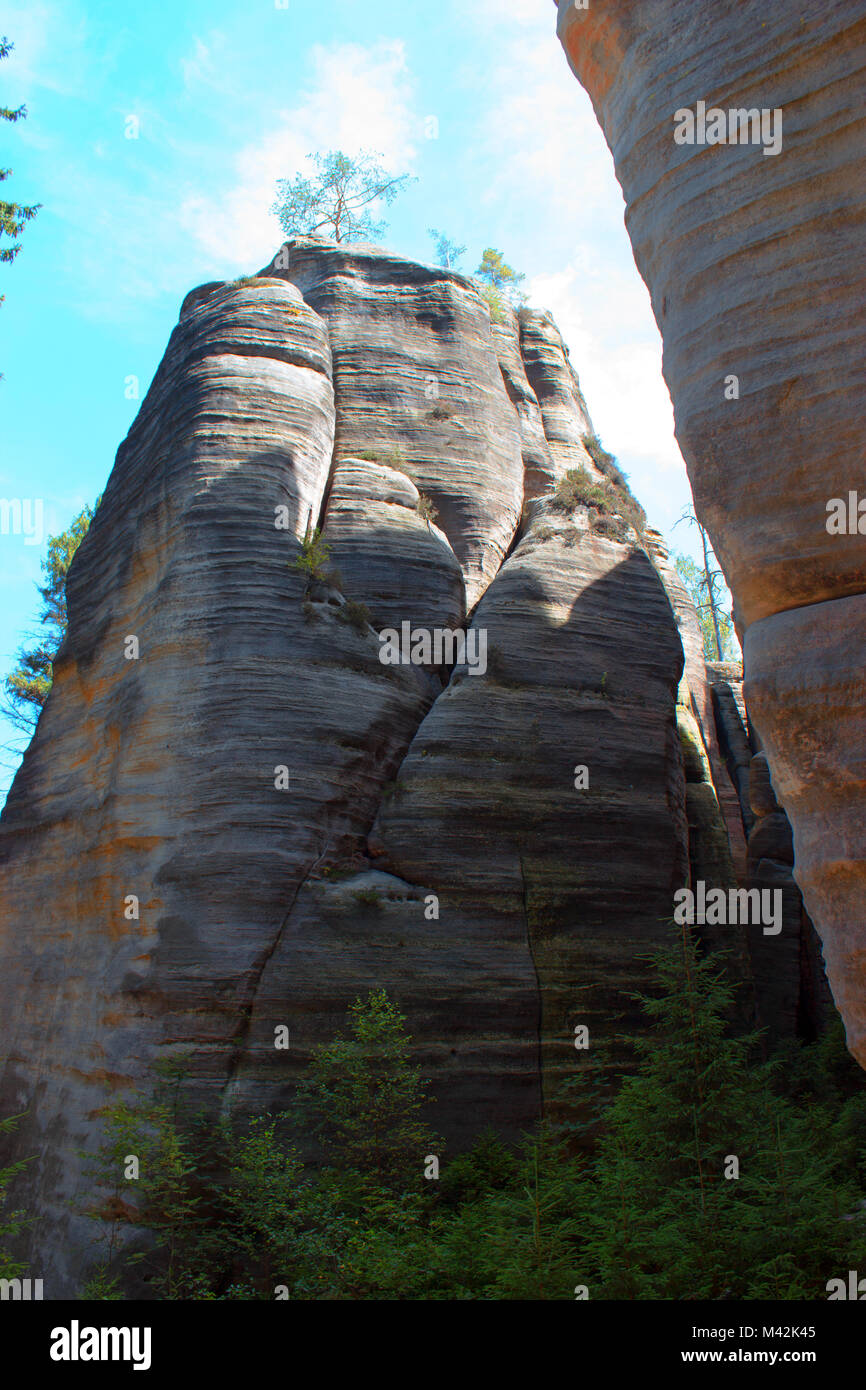 In the foreground are seen tree branches in the background and right is the Rock. Stock Photo