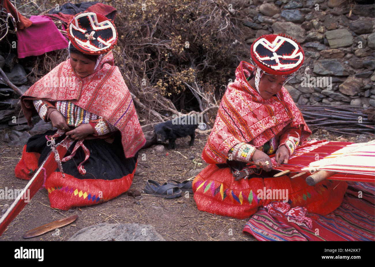 Peru. Huilloc or Willoc. Near Ollantaytambo and Cusco, Cuzco,  Women weaving in traditional clothing on countryside. Stock Photo