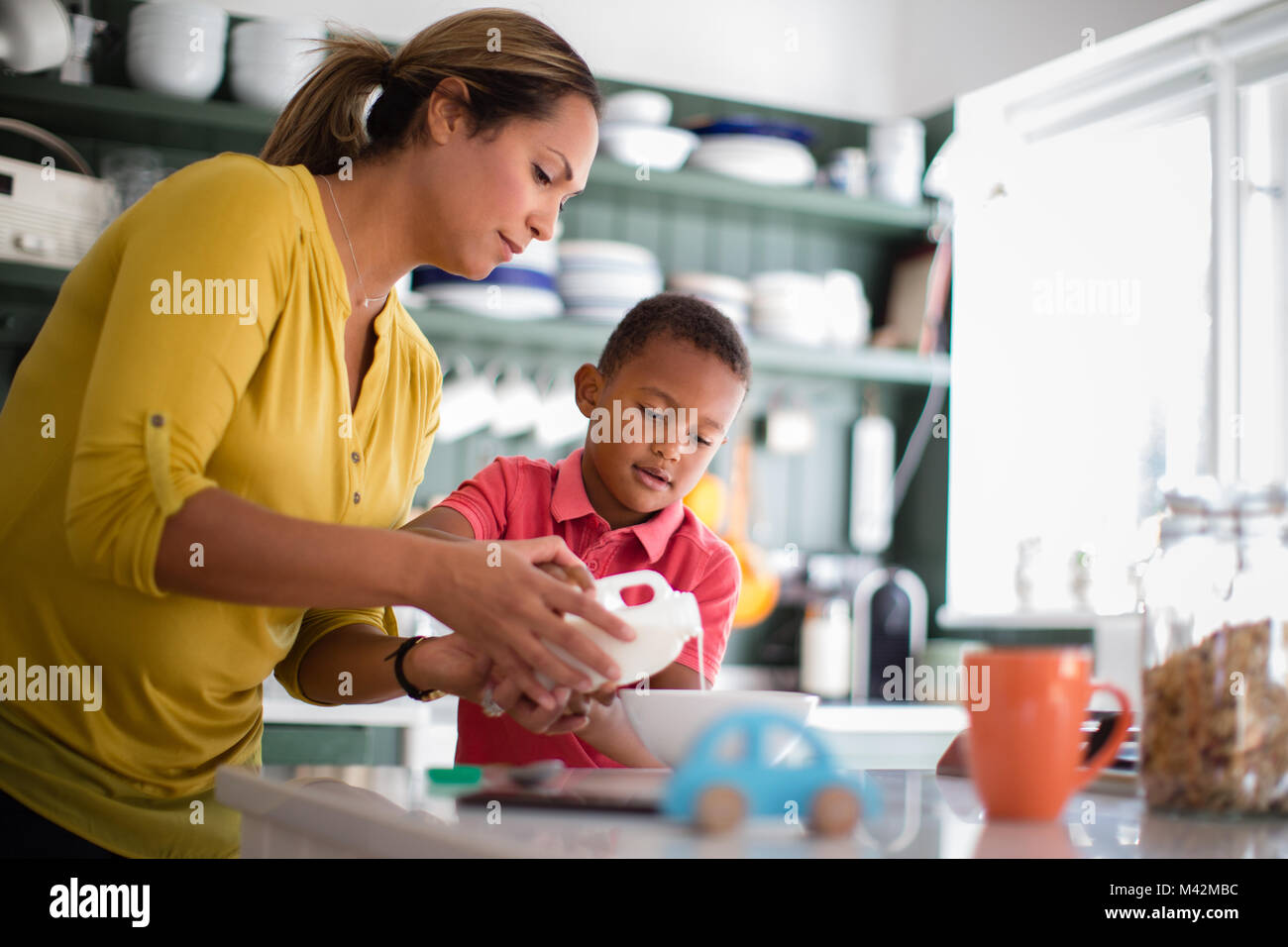 Mum helping son with breakfast Stock Photo