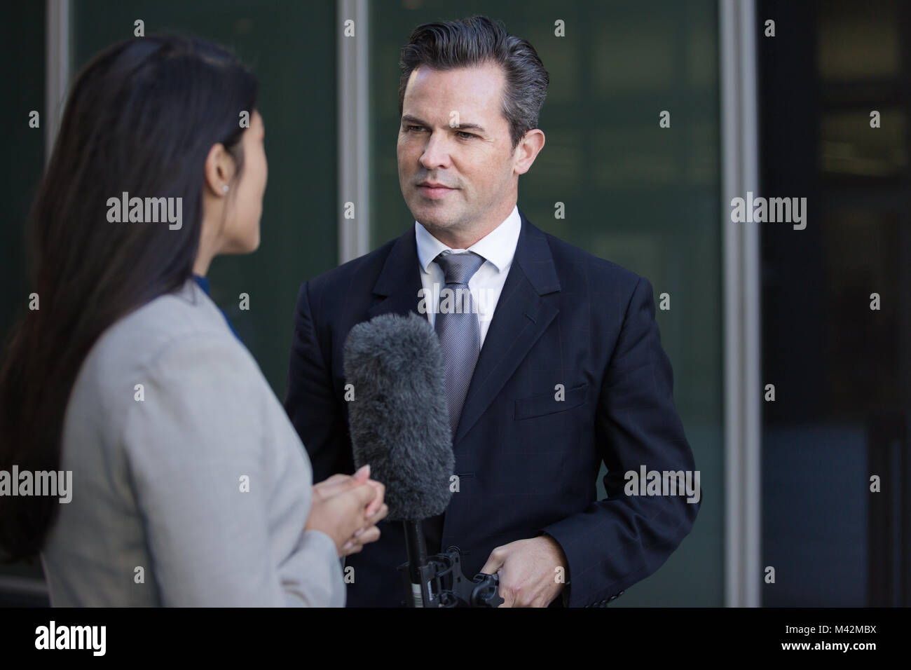 Politician being interviewed on the street Stock Photo