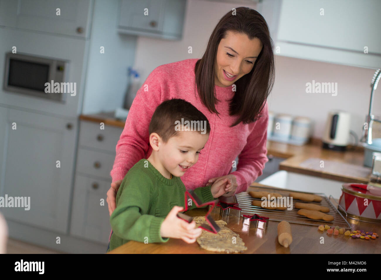 Mother and Son baking cookies in kitchen Stock Photo