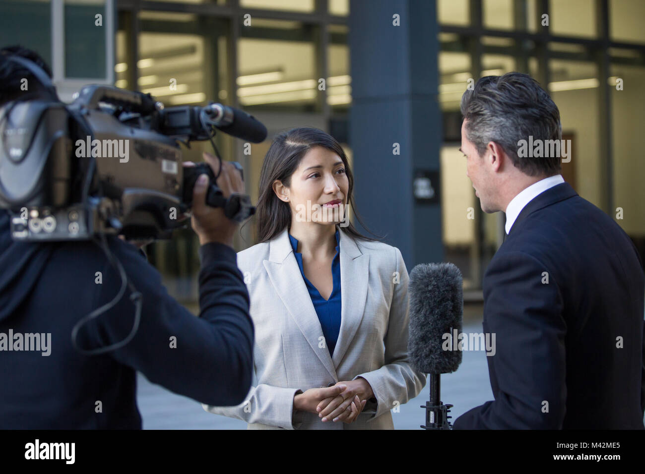 News presenter interviewing on the street Stock Photo