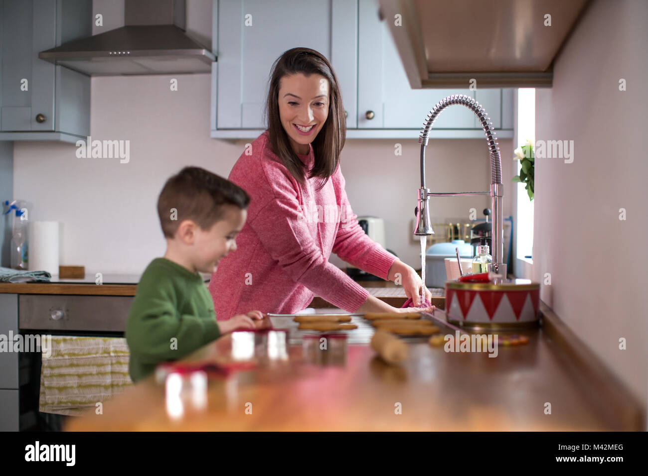 Mother and Son baking cookies in kitchen Stock Photo
