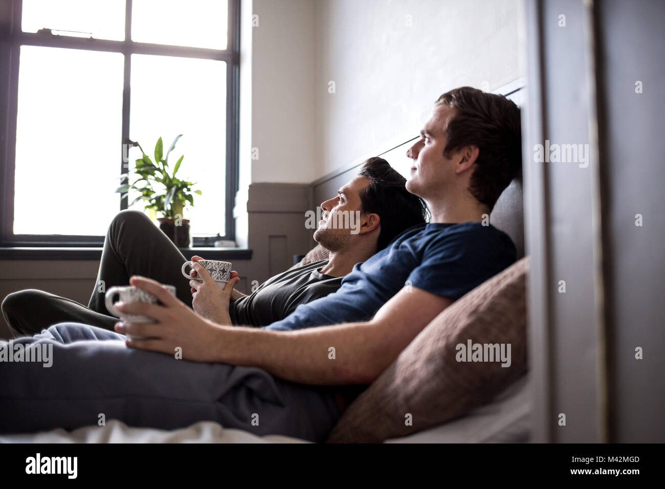 Young male couple relaxing with coffee Stock Photo
