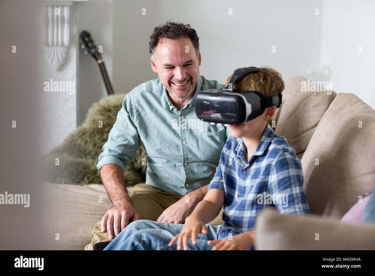 Boy using a VR headset game at home Stock Photo