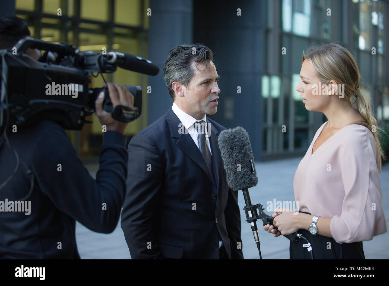 Businessman being interviewed on the street Stock Photo